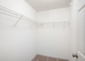 Thumbnail 15 of 45 - an empty closet with a metal rack on the wall at Cityscape, St Louis Park, MN, 55416