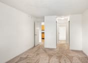 Thumbnail 12 of 45 - a spacious living room with white walls and a carpeted floor at Cityscape, St Louis Park, 55416