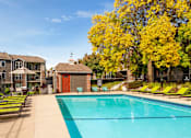 Thumbnail 24 of 30 - Outdoor pool with lounge chairs at Eden Commons in Eden Prairie, MN 55344