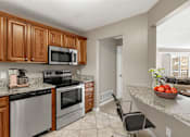 Thumbnail 1 of 26 - Kitchen with stainless steel appliances and quartz countertops at The Riverwood in Lilydale, MN 55118