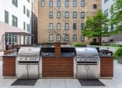 Thumbnail 21 of 25 - the outdoor kitchen has stainless steel appliances and a grill and a bar with a wood  at The Cosmopolitan, St Paul, Minnesota
