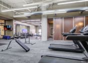 Thumbnail 14 of 25 - a gym with treadmills and other exercise equipment  at The Cosmopolitan, St Paul, Minnesota