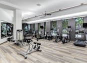 Thumbnail 11 of 22 - A gym with a variety of exercise equipment.