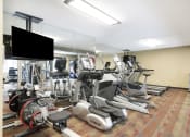Thumbnail 9 of 12 - a room filled with cardio equipment and a flat screen tv  at The Kendrick, Minnesota, 55108