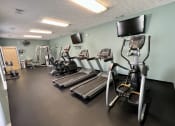 Thumbnail 7 of 14 - a gym with cardio equipment and a tv at Shenandoah Properties in Lafayette, IN 47905