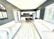 Thumbnail 7 of 14 - a living room with couches and a table at Murdock Gardens Apartments, Lafayette, IN 47904