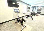 Thumbnail 6 of 14 - a room with three treadmills and a tv on the wall at Murdock Gardens Apartments, Lafayette, IN 47904