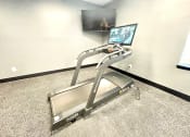 Thumbnail 5 of 14 - a treadmill in front of a flat screen tv at Murdock Gardens Apartments, Lafayette, IN 47904