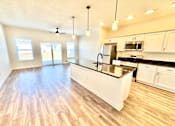 Thumbnail 18 of 37 - A kitchen with white cabinets and a black countertop.at Concord Crossing, Lafayette  