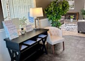 Thumbnail 5 of 19 - A reception desk with a white chair and a sign that reads "Shamrock Proposal" in front of a window with blinds.