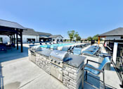 Thumbnail 49 of 49 - A row of outdoor grills are lined up on a patio.