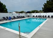 Thumbnail 19 of 19 - A pool with a person in a blue jacket standing by it.