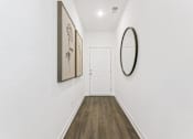 Thumbnail 10 of 25 - Welcoming hallway with warm wood flooring throughout