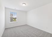 Thumbnail 17 of 27 - A room with a window and a grey carpet.