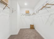 Thumbnail 25 of 25 - Spacious walk-in closet with built-in shelving system