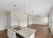 Thumbnail 27 of 44 - A kitchen with a granite countertop and a sink.