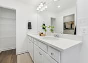 Thumbnail 23 of 25 - Elegant bathroom featuring double vanity and designer lighting
