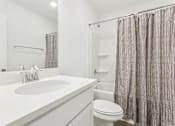 Thumbnail 20 of 25 - Sleek bathroom with soaking tub and shower combination
