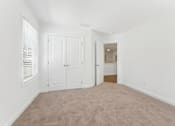 Thumbnail 24 of 25 - Bright bedroom with plush carpet and ample closet space
