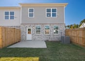 Thumbnail 14 of 25 - Spacious backyard with privacy fence and patio area