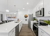 Thumbnail 2 of 25 - Gourmet kitchen featuring center island and stainless appliances