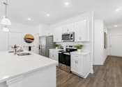 Thumbnail 1 of 25 - Pristine kitchen with sleek cabinetry and open layout