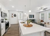 Thumbnail 3 of 25 - Modern white kitchen with abundant counter space