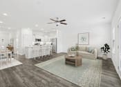 Thumbnail 3 of 27 - A living room with a couch, coffee table, and a dining table.