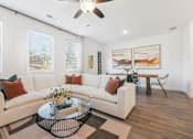 Thumbnail 9 of 25 - Bright living room with stylish sectional and dining area
