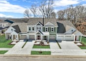 Thumbnail 19 of 20 - A large, two-story house with a garage and a driveway.