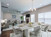 Thumbnail 5 of 19 - A dining room with a white table and chairs.