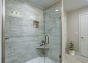 Thumbnail 10 of 19 - A bathroom with a walk-in shower and a white door.