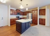 Thumbnail 21 of 28 - an empty kitchen with a large island in the middle