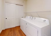 Thumbnail 27 of 28 - a washer and dryer in a room with a closet