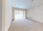 Thumbnail 28 of 28 - an empty living room with a door to a balcony