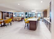 Thumbnail 20 of 28 - a large kitchen with a long bar and yellow chairs