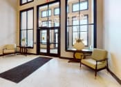 Thumbnail 17 of 28 - a lobby with large windows and chairs and a rug