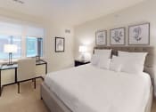 Thumbnail 24 of 28 - a white bedroom with a large bed and a window