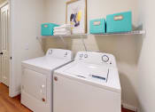 Thumbnail 25 of 28 - a washer and dryer in a room with a shelf on the wall