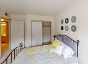 Thumbnail 17 of 28 - a bedroom with a bed and a door to a bathroom