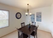 Thumbnail 13 of 28 - a dining room with a table and chairs and a clock on the wall