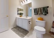 Thumbnail 4 of 26 - a bathroom with a toilet sink and mirror