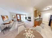 Thumbnail 20 of 21 - a living room and kitchen with a table and chairs