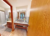 Thumbnail 17 of 21 - a bathroom with a sink and a toilet and a mirror