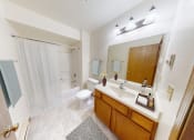 Thumbnail 7 of 35 - a bathroom with a sink and a toilet and a shower