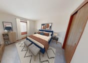 Thumbnail 6 of 35 - a bedroom with a bed and a tv in the corner of a room