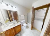 Thumbnail 11 of 19 - a bathroom with a sink toilet and a washer and dryer