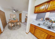 Thumbnail 13 of 19 - a kitchen and dining room with a table and chairs