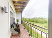 Thumbnail 12 of 64 - a balcony with a couch and a cat on it