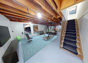 Thumbnail 33 of 42 - a home gym with a staircase and a tv